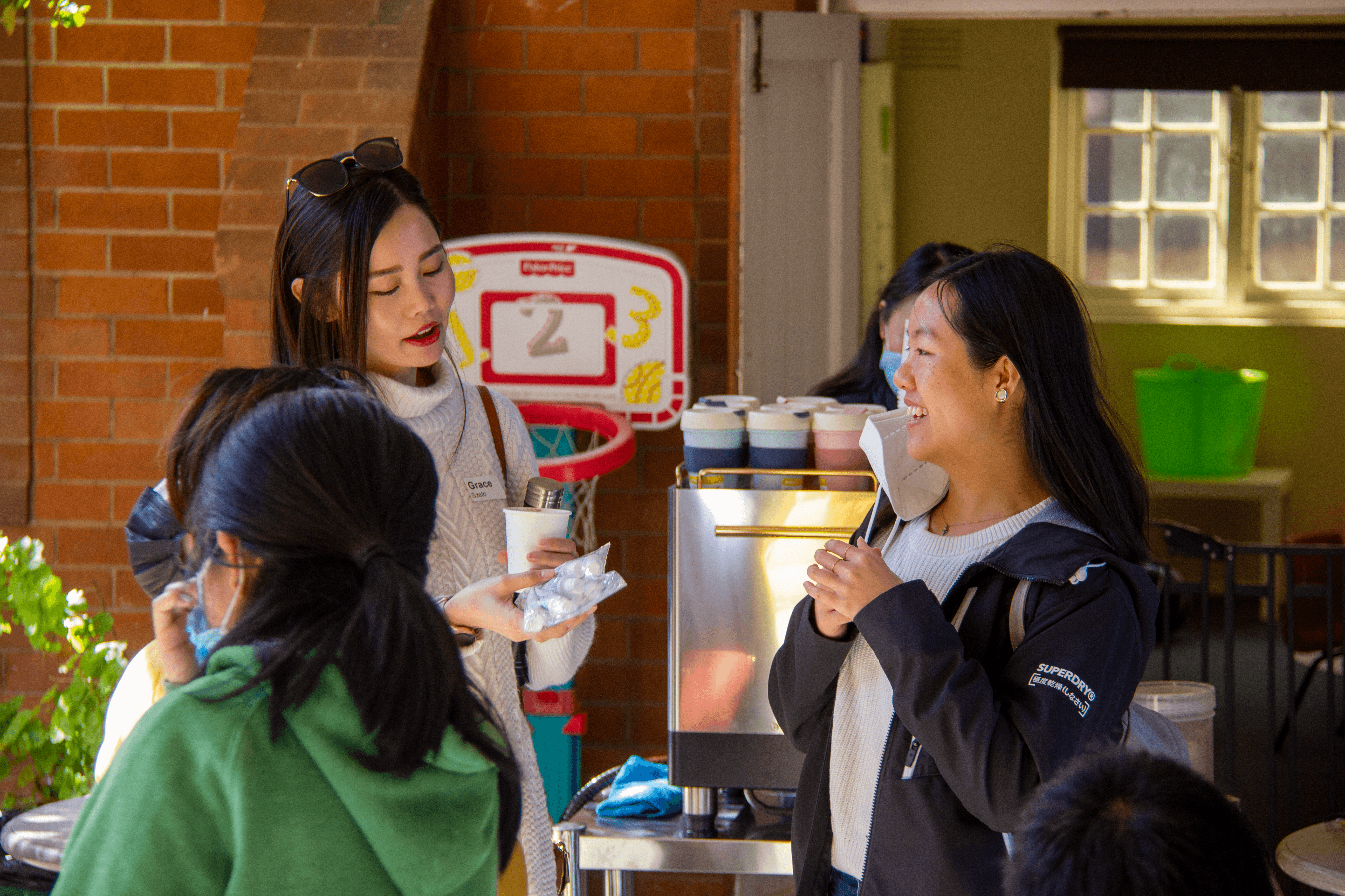 Women talking in front of a coffee machine